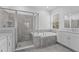 Elegant bathroom featuring a soaking tub, glass shower, and dual sink vanity at 5376 Dagenham Dr, Davenport, FL 33837