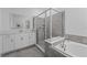 Bathroom featuring a glass shower, soaking tub, and vanity with plenty of storage at 5376 Dagenham Dr, Davenport, FL 33837