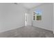 Bedroom featuring carpeted flooring, a window with a view, and a white door at 5376 Dagenham Dr, Davenport, FL 33837