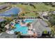 Aerial view of a resort-style community pool with water slides, seating areas, and lush landscaping at 5376 Dagenham Dr, Davenport, FL 33837