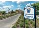 Community entrance sign surrounded by lush landscaping and palm trees at 5376 Dagenham Dr, Davenport, FL 33837