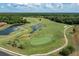 Scenic aerial of a well-maintained golf course with a meandering water feature and lush green landscape at 5376 Dagenham Dr, Davenport, FL 33837