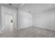 Hallway leading to a bright room with tile flooring and crisp, white walls at 5376 Dagenham Dr, Davenport, FL 33837