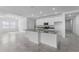 Modern kitchen features a large central island, and connects to a naturally lit living space at 5376 Dagenham Dr, Davenport, FL 33837