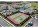 Aerial view highlighting tennis courts and community amenities, nestled within a vibrant residential community at 5376 Dagenham Dr, Davenport, FL 33837