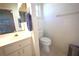 Bathroom featuring a toilet, white vanity, and window at 6065 Dory Way, Tavares, FL 32778