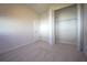 Bedroom with neutral carpet features a closet with plenty of storage at 6065 Dory Way, Tavares, FL 32778