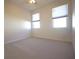 Spacious bedroom featuring neutral carpet and two windows at 6065 Dory Way, Tavares, FL 32778