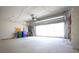 Spacious garage with ample lighting and an automatic door opener at 6065 Dory Way, Tavares, FL 32778