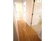 Hallway with wood flooring transitions to carpeted bedrooms at 6065 Dory Way, Tavares, FL 32778