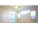 Bright main bedroom with sliding glass doors leading to a sunroom or patio at 6065 Dory Way, Tavares, FL 32778