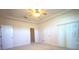 Large main bedroom showing ensuite bathroom access, closet, and sliding glass door at 6065 Dory Way, Tavares, FL 32778