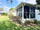 This home has a screened-in porch for relaxing outside with views of the lawn and garden at 6065 Dory Way, Tavares, FL 32778