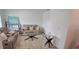 Neutral-toned living room featuring a reclining sofa set, decorative tables, and a patterned area rug at 643 Taft Dr, Davenport, FL 33837