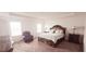 Spacious main bedroom featuring a tray ceiling, chair, and dark wood furniture at 643 Taft Dr, Davenport, FL 33837