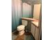 Simple bathroom featuring a shower with curtain, toilet, and vanity with a sink at 719 Del Ray Dr, Kissimmee, FL 34758