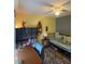 Bedroom featuring daybed, ceiling fan, accent rug, and wall shelving at 719 Del Ray Dr, Kissimmee, FL 34758