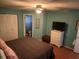 Comfortable primary bedroom with an ensuite bathroom, closet, and neutral decor at 719 Del Ray Dr, Kissimmee, FL 34758