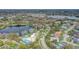 An aerial view of the property in a neighborhood near a scenic lake and a commercial area at 7531 Lodge Pole Trl, Winter Park, FL 32792