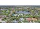 An aerial view of the property in a neighborhood near a scenic lake at 7531 Lodge Pole Trl, Winter Park, FL 32792