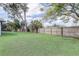 Large grassy back yard area with lush landscaping and perimeter fencing at 7531 Lodge Pole Trl, Winter Park, FL 32792