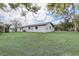 Side yard showing house exterior and sprawling back yard area at 7531 Lodge Pole Trl, Winter Park, FL 32792