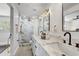 Bathroom featuring white marble shower and dual vanity with modern black fixtures at 7531 Lodge Pole Trl, Winter Park, FL 32792