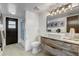 Bright bathroom features white square tiles, modern vanity with vessel sink, and a glass-enclosed shower at 7531 Lodge Pole Trl, Winter Park, FL 32792