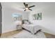 Bright bedroom with a soft rug, comfortable bed, and a ceiling fan at 7531 Lodge Pole Trl, Winter Park, FL 32792