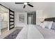 Bedroom with grey-scale color palette, featuring a dark-framed sliding door to an ensuite bathroom at 7531 Lodge Pole Trl, Winter Park, FL 32792