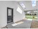 Welcoming entryway with a stylish black front door and bright skylights above at 7531 Lodge Pole Trl, Winter Park, FL 32792