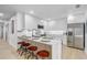 Modern kitchen with marble countertops, stainless steel appliances, and an island with seating at 7531 Lodge Pole Trl, Winter Park, FL 32792