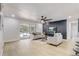 This comfortable living space features light flooring, a stylish accent wall, and glass doors to the pool at 7531 Lodge Pole Trl, Winter Park, FL 32792