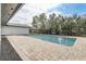 Backyard pool with brick pavers and lush green landscaping at 7531 Lodge Pole Trl, Winter Park, FL 32792