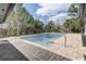 Sparkling private pool surrounded by lush landscaping and a brick patio at 7531 Lodge Pole Trl, Winter Park, FL 32792