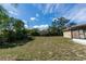 Grassy backyard featuring a screened-in porch and a shed at 759 Swallow St, Deltona, FL 32725