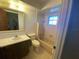 Bathroom with shower and tub, toilet and vanity with mirror at 759 Swallow St, Deltona, FL 32725