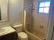 Bathroom with shower and tub, toilet and vanity with mirror at 759 Swallow St, Deltona, FL 32725