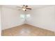 The bright bedroom has neutral tile flooring, two windows, and white walls at 759 Swallow St, Deltona, FL 32725