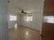 Cozy bedroom featuring tile floors, a ceiling fan, and two windows offering natural light at 759 Swallow St, Deltona, FL 32725