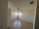 Neutral bedroom features tiled floor, ceiling fan and natural light from the two windows at 759 Swallow St, Deltona, FL 32725