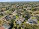 Aerial view of a well-maintained property with a screened pool, nestled in a lush, established neighborhood at 7609 Sandstone Dr, Orlando, FL 32836