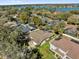 Aerial shot of a property with a screened pool, surrounded by lush landscaping and a tranquil lake nearby at 7609 Sandstone Dr, Orlando, FL 32836