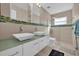 Contemporary bathroom with double sinks, a walk-in shower, and modern fixtures at 7609 Sandstone Dr, Orlando, FL 32836