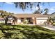 Charming single-story home with a well-manicured lawn and inviting front entrance at 7609 Sandstone Dr, Orlando, FL 32836