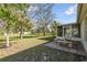 The back yard features a screened-in porch and stone table for outdoor dining at 939 Van Loon Ct, Kissimmee, FL 34758