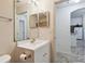 Well-lit bathroom featuring a white vanity with chrome faucet and a large mirror at 939 Van Loon Ct, Kissimmee, FL 34758