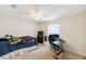 A bedroom with a ceiling fan, window, and desk area at 939 Van Loon Ct, Kissimmee, FL 34758