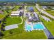 An aerial view of community amenities featuring a pool, basketball court, and pond at 939 Van Loon Ct, Kissimmee, FL 34758