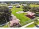 An aerial view of the community playground featuring multiple swings, slides, and sunshades at 939 Van Loon Ct, Kissimmee, FL 34758